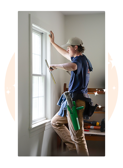 Homeowner seeing professional window cleaner using squeegee on interior garage window — first-time professional window cleaning service in Exton PA