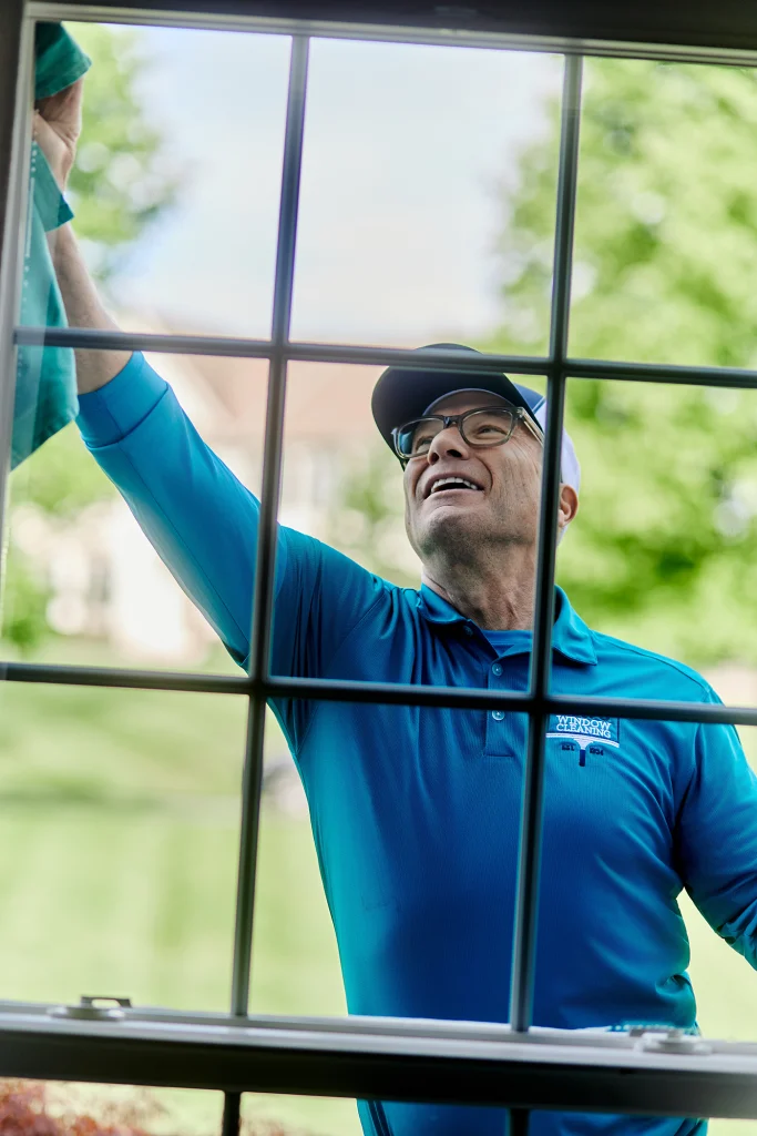 Upper-floor window cleaning using professional equipment to safely reach exterior glass