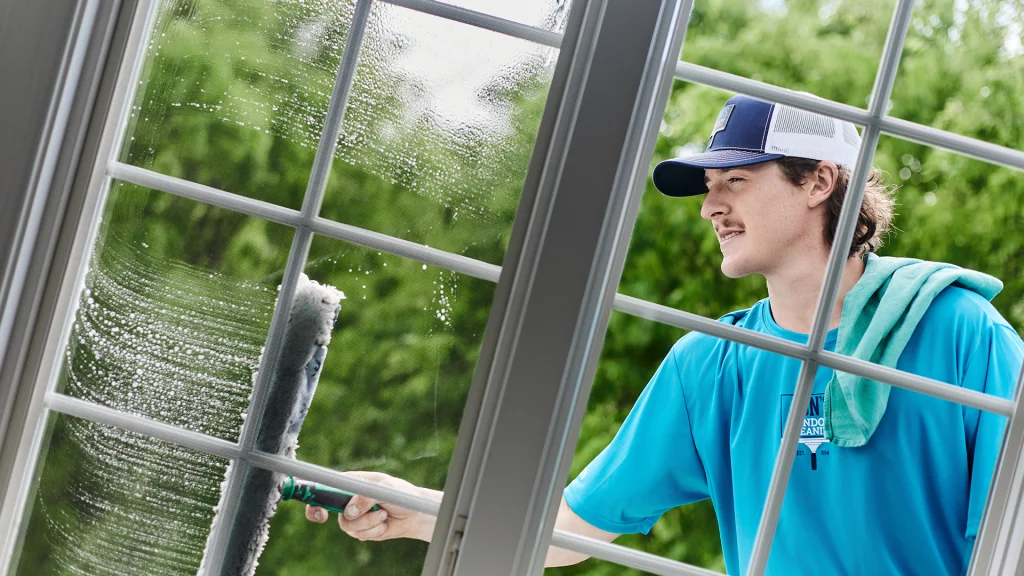 Professional residential window cleaning in Chester County PA – technician cleaning a home window for a streak-free finish