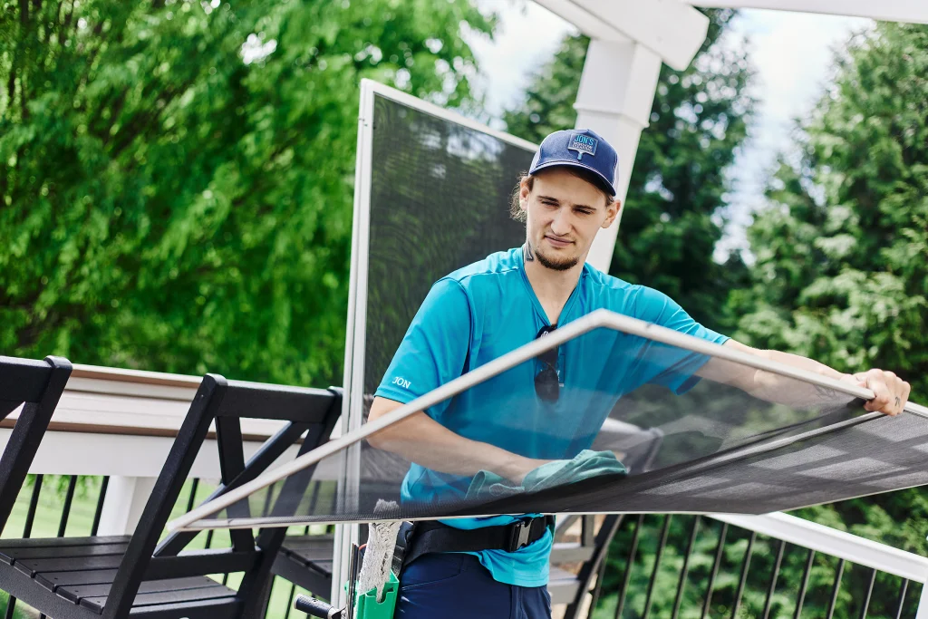 Outside window cleaning service removing dirt and buildup from residential house windows
