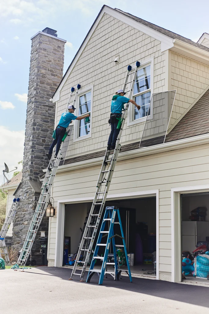 Home window washing professionals cleaning residential windows inside and outside