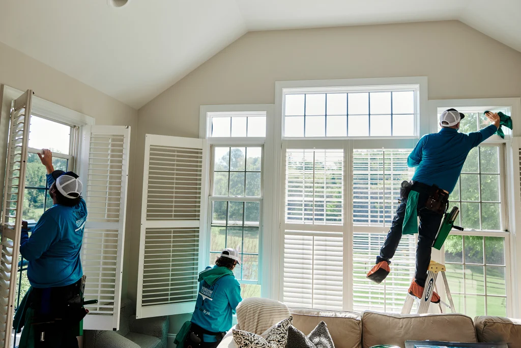 Professional exterior window cleaning on hard-to-reach second-story house windows